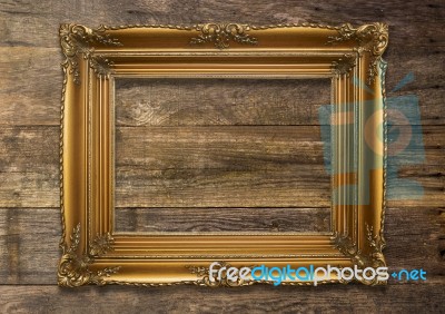 Old Brown Picture Frame On Wooden Background Stock Photo