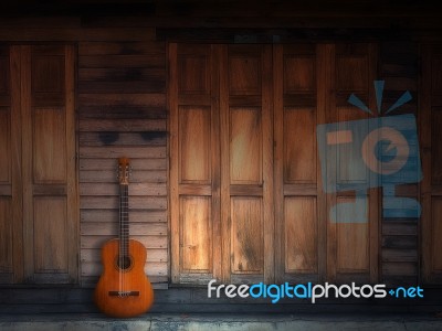Old Classic Guitar On Wood Wall Stock Photo