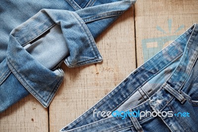 Old Jeans On Wooden Stock Photo