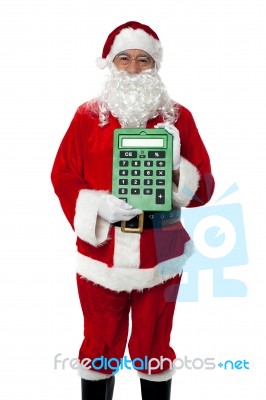 Old Man Dressed As Santa Showing A Large Green Calculator Stock Photo