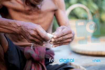 Old Men Are Wrapped A Cigarette Stock Photo