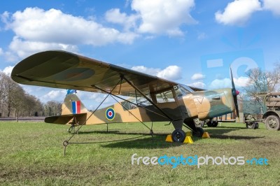 Old Military Airplane On Green Grass With Blue Sky And White Clo… Stock Photo