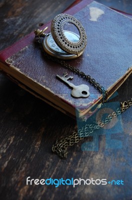 Old Pocket Watch, Book And A Key Stock Photo