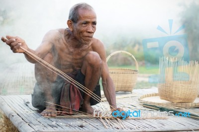 Older Asian Men Sit Are Weaving Stock Photo
