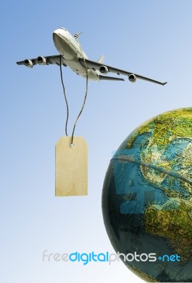 One Airplane Hanging With Black Wooden Price Tag Over The Earth Stock Photo