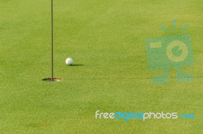 One Golf Ball Near The Hole Stock Photo