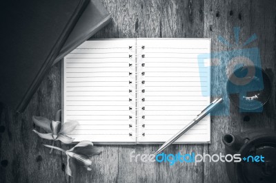 Open Notebook And Pen On Old Wooden Background, Black And White Stock Photo
