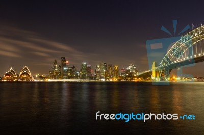 Opera House And Harbour Bridge In Sydney At Night, It Is Illumin… Stock Photo
