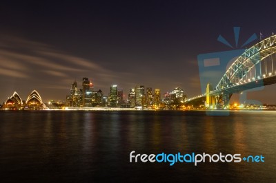 Opera House And Harbour Bridge In Sydney At Night, It Is Illumin… Stock Photo