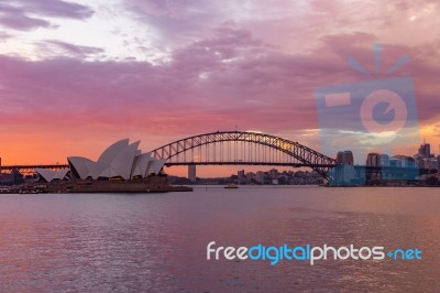Opera House And Harbour Bridge In Sydney At Night, It Is Illuminated By Golden Lights .australia Stock Photo