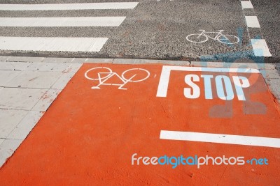 Orange Bicycle Lane With A Stop Sign Stock Photo