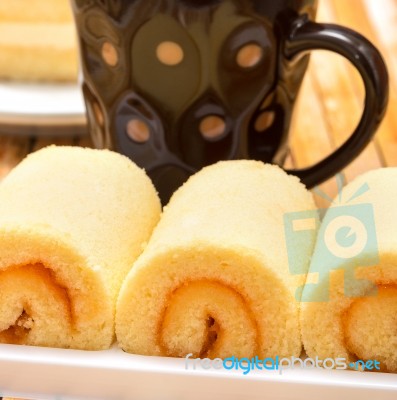 Orange Flavored Cake Represents Coffee Swiss Roll And Beverage Stock Photo