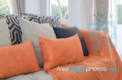 Orange Pillows And Blanket On Modern Sofa In Living Room Stock Photo Orange Pillows And Blanket On Modern Sofa In Living Room Stock Photo