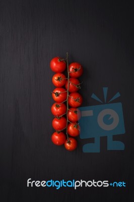 Organic Fresh Cherry Tomatoes On Black Board Background Stock Photo