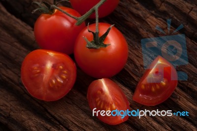 Organic Fresh Cherry Tomatoes On Wooden Background Stock Photo