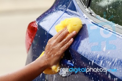Outdoor Blue Car Wash With Yellow Sponge Stock Photo