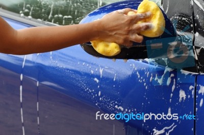 Outdoor Blue Car Wash With Yellow Sponge Stock Photo