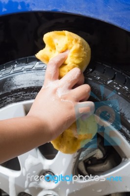 Outdoor Tire Car Wash With Yellow Sponge Stock Photo