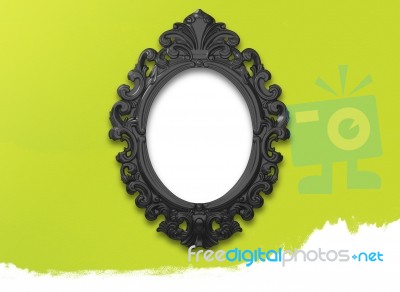 Oval Black Picture Frame With A Decorative On Green Wall Stock Image