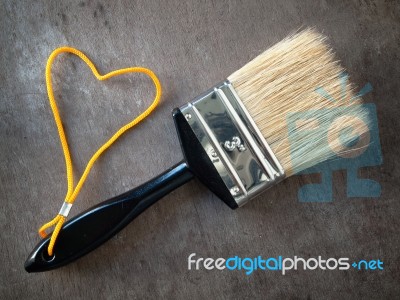 Paint Brush With A Yellow Rope Stock Photo