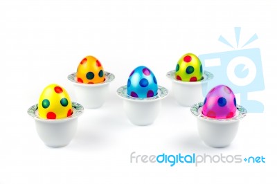 Painted Easter Eggs Standing In Porcelain Egg Cups On White Stock Photo