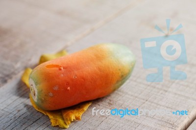 Papaya On Wooden Floor Stock Photo