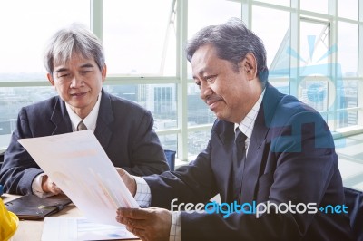 Partner Of Senior Engineering Working Man Serious Meeting About Project Discussing Solution Shot On Table In Office Meeting Room Stock Photo