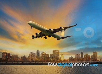 Passenger Plane Flying Above Urban Scene Use For Convenience Air… Stock Photo