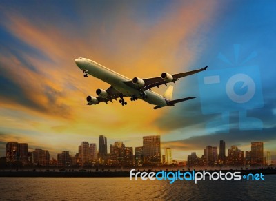 Passenger Plane Flying Above Urban Scene Use For Convenience Air… Stock Photo