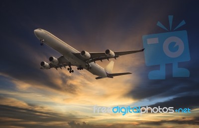 Passenger Plane Flying On Beautiful  Dusky Sky Stock Photo