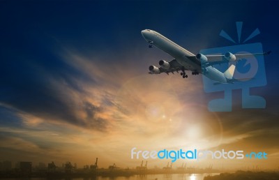 Passenger Plane Flying On Beautiful  Dusky Sky Stock Photo