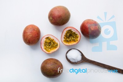Passion Fruit With Salt In Wooden Spoon On Wooden White Backgrou… Stock Photo
