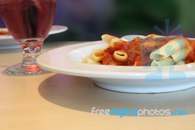 Pasta And Tomato Sauce Dish On Table Stock Photo