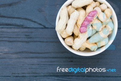 Peanuts In The Bow On Wooden Stock Photo
