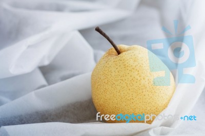 Pear On White Tablecloth Stock Photo