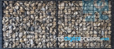 Pebble Stones In Iron Mesh Stock Photo