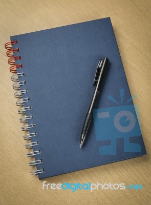 Pen And Notebook On Wooden Table Stock Photo