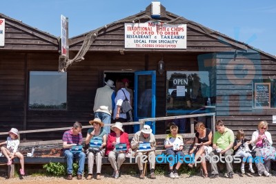 People Enjoying Fish And Chips In Southwold Suffolk Stock Photo