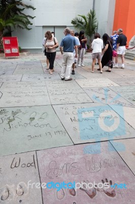 People Looking At The Handprints Footprints And Signatures Of Th… Stock Photo