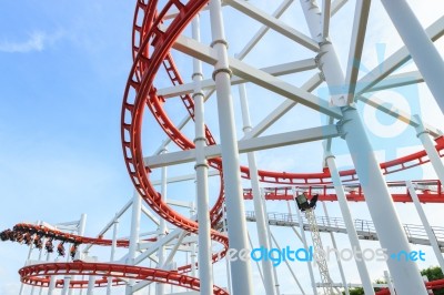 People Play Roller Coaster In Amusement Park Stock Photo