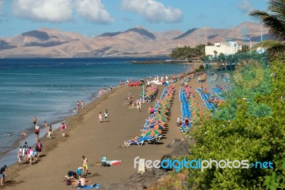 People Relaxing On A Beach In Lanzarote Stock Photo