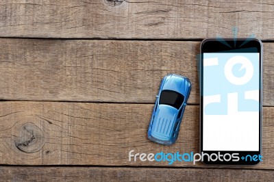 Phone And Car Model Toy On Wood Table Top View Stock Photo
