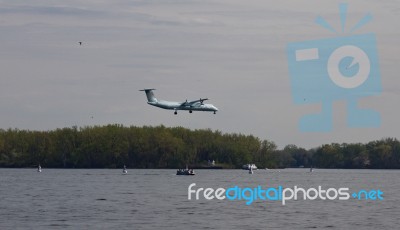 Photo With The Landing Blue Plane And The Lake Stock Photo
