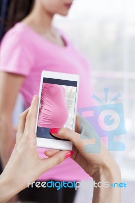 Photographing Pregnant Women Ith Smart Phone Stock Photo