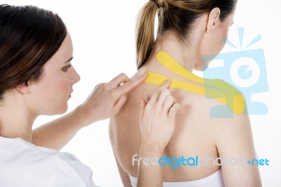 Physiotherapist Gets Taping On The Trapezius Stock Photo
