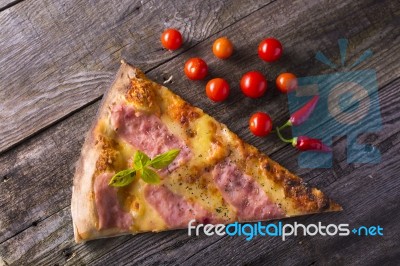Piece Of Hot Pizza On Wooden Table, Cherry Tomato And Hot Pepper… Stock Photo
