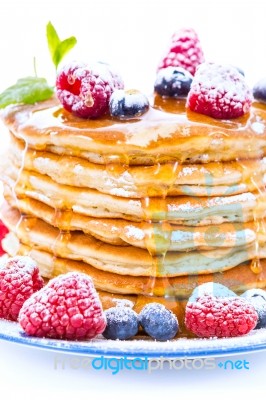 Pile Of Pancakes With Blueberries And Raspberries Sprinkled With… Stock Photo