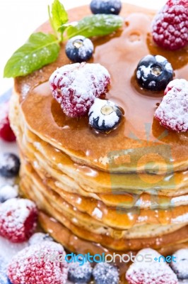 Pile Of Pancakes With Blueberries And Raspberries Sprinkled With… Stock Photo