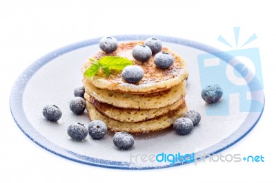 Pile Of Pancakes With Blueberries Sprinkled With Icing Sugar Stock Photo