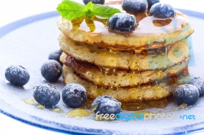 Pile Of Pancakes With Blueberries Sprinkled With Icing Sugar And… Stock Photo